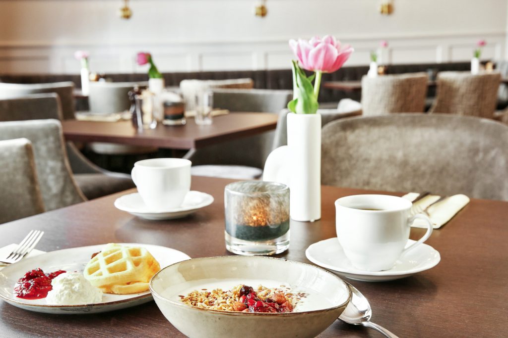 Breakfast with muesli and coffee served in restaurant setting